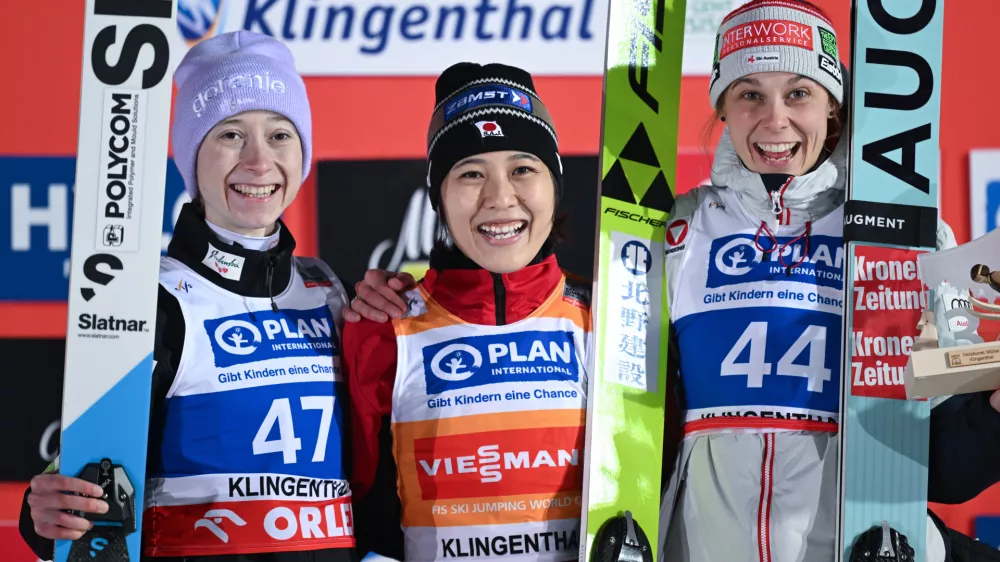 Nozomi Maruyam, center, of Japan, winner of the ski jumping, women's World Cup large hill event, poses on the podium with second placed Nika Prevc of Slovenia, left, and third placed Lisa Eder of Austria, in Klingenthal, Germany, Friday, Dec. 12, 2025. (Hendrik Schmidt/dpa via AP)