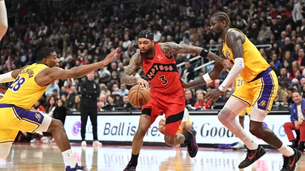 Dec 4, 2025; Toronto, Ontario, CAN; Toronto Raptors forward Brandon Ingram (3) dribbles the ball between Los Angeles Lakers forward Rui Hachimura (28) and center Deandre Ayton (5) in the second half at Scotiabank Arena. Mandatory Credit: Dan Hamilton-Imagn Images