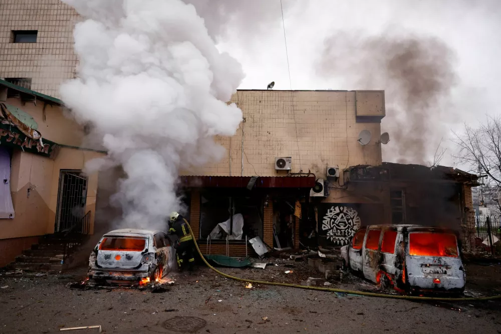 A firefighter extinguishes a fire in a car damaged during a Russian missile and drone attack on Kyiv, amid Russia's attack on Ukraine, November 29, 2025. REUTERS/Valentyn Ogirenko