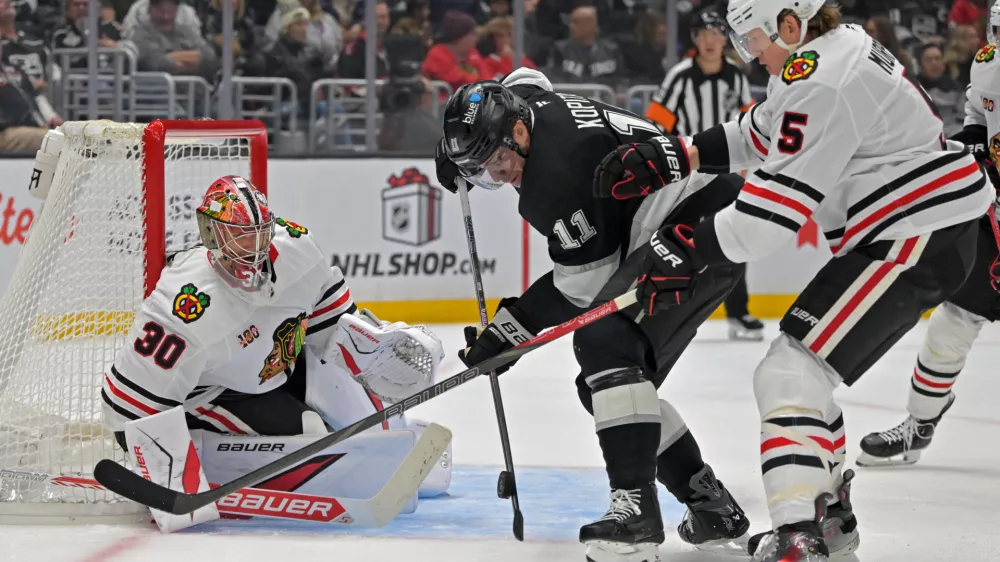 Dec 4, 2025; Los Angeles, California, USA; Chicago Blackhawks defenseman Connor Murphy (5) uses his stick to defend Los Angeles Kings center Anze Kopitar (11) as Chicago Blackhawks goaltender Spencer Knight (30) defends the net during the second period at Crypto.com Arena. Mandatory Credit: Jayne Kamin-Oncea-Imagn Images