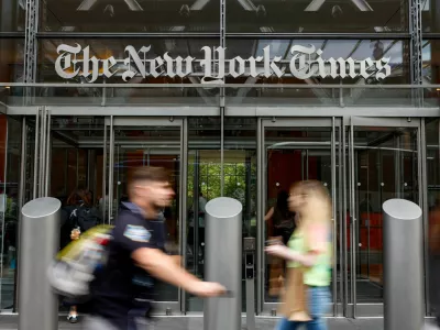 FILE PHOTO: People walk by The New York Times building in Manhattan, New York City, U.S., September 16, 2025. U.S. President Donald Trump has filed a  billion defamation lawsuit against the New York Times and book publisher Penguin Random House. REUTERS/Kylie Cooper/File Photo