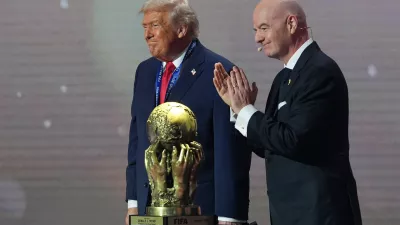 President Donald Trump receives the FIFA Peace Prize from FIFA President Gianni Infantino during the draw for the 2026 soccer World Cup at the Kennedy Center in Washington, Friday, Dec. 5, 2025. (AP Photo/Jacquelyn Martin)