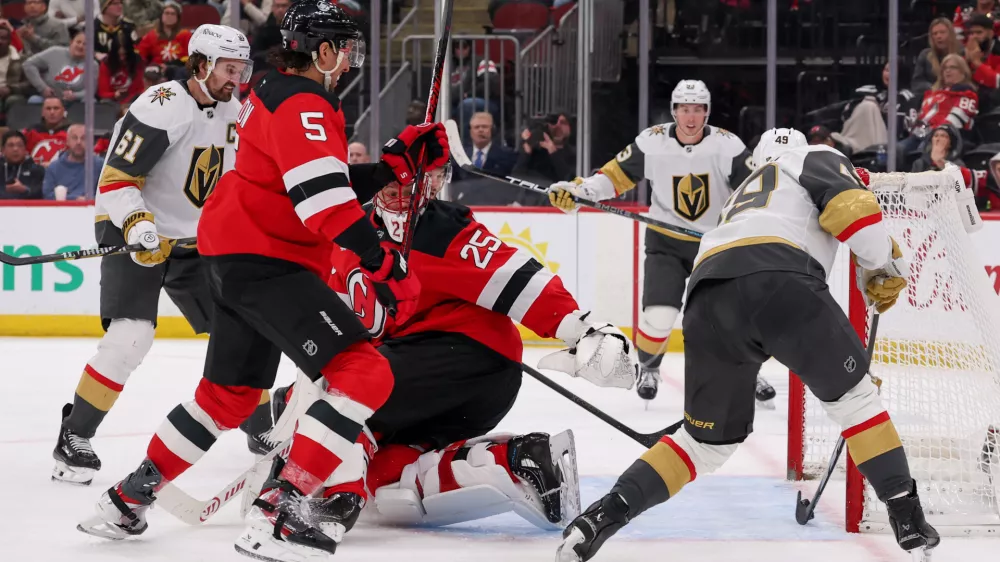 Dec 5, 2025; Newark, New Jersey, USA; Vegas Golden Knights left wing Ivan Barbashev (49) scores a goal on New Jersey Devils goaltender Jacob Markstrom (25) during the third period at Prudential Center. Mandatory Credit: Ed Mulholland-Imagn Images