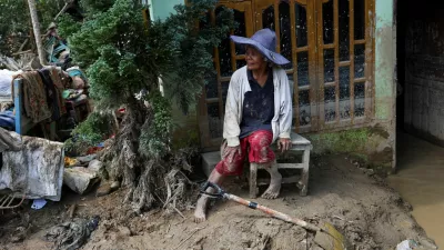 Survivor Rismawati Simanjuntak, 63, sits as she takes a break while collecting valuable goods and cleaning her house following deadly flash flood in Batang Toru, South Tapanuli, North Sumatra province, Indonesia, December 6, 2025. REUTERS/Willy Kurniawan