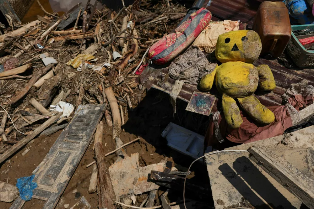 A doll lies among other goods in front of a house at an area following deadly flash flood in Batang Toru, South Tapanuli, North Sumatra province, Indonesia, December 6, 2025. REUTERS/Willy Kurniawan