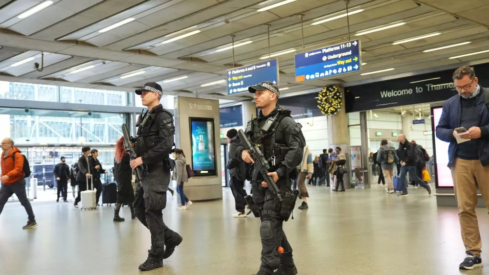 Armed police officers go on patrol at St Pancras International train station in London, England, Monday, Nov. 3, 2025. (Yui Mok/PA via AP)