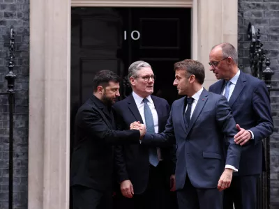 Ukraine's President Volodymyr Zelenskiy and French President Emmanuel Macron shake hands on the 10 Downing Street doorstep after a meeting with Britain's Prime Minister Keir Starmer and Germany's Chancellor Friedrich Merz, in London, Britain, December 8, 2025. ADRIAN DENNIS/Pool via REUTERS