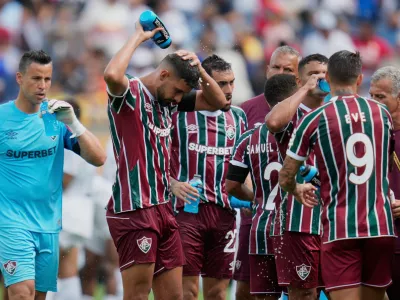 FILE - Fluminense players cooling up during a water break at the Club World Cup quarterfinal soccer match between Fluminense and Al Hilal in Orlando, Fla., Friday, July 4, 2025. (AP Photo/John Raoux, file)