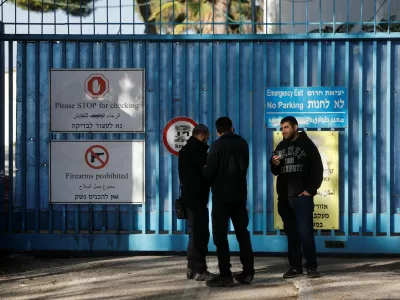 Israeli police officers wait outside the United Nations Relief and Works Agency for Palestine Refugees (UNRWA) headquarters, in Jerusalem December 8, 2025. REUTERS/Ammar Awad