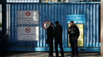 Israeli police officers wait outside the United Nations Relief and Works Agency for Palestine Refugees (UNRWA) headquarters, in Jerusalem December 8, 2025. REUTERS/Ammar Awad