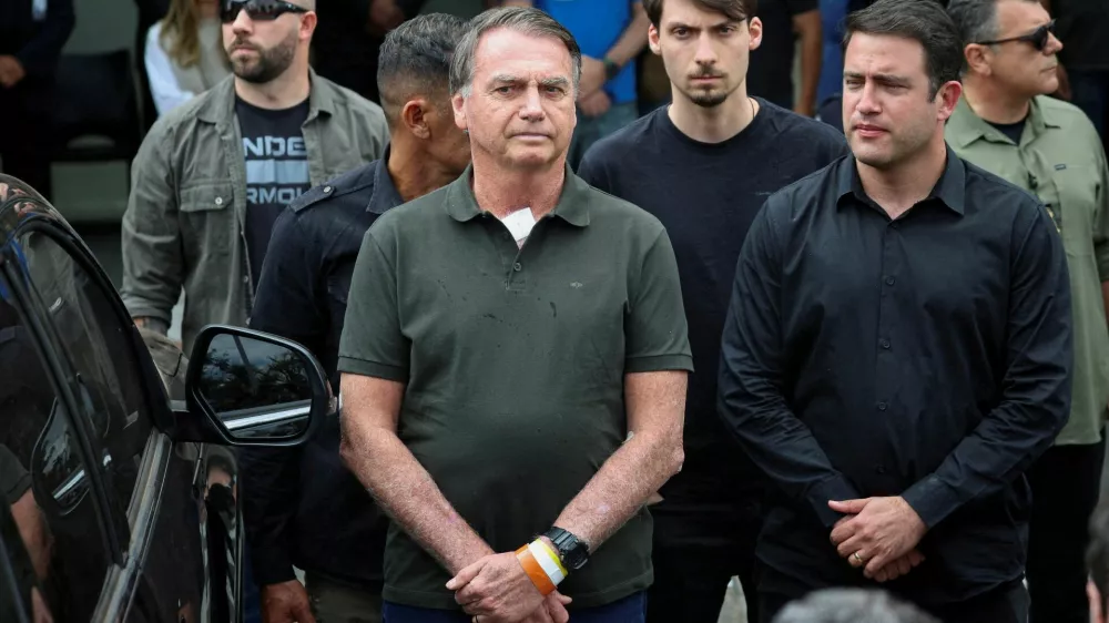 FILE PHOTO: Former Brazilian President Jair Bolsonaro leaves the hospital where he went to undergo a skin surgery procedure, authorized by Supreme Court Justice Alexandre de Moraes, leaving the house arrest after being convicted by a Supreme Court majority of plotting a coup to remain in power after losing the 2022 election, in Brasilia, Brazil, September 14, 2025. REUTERS/Adriano Machado   TPX IMAGES OF THE DAY/File Photo