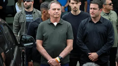 FILE PHOTO: Former Brazilian President Jair Bolsonaro leaves the hospital where he went to undergo a skin surgery procedure, authorized by Supreme Court Justice Alexandre de Moraes, leaving the house arrest after being convicted by a Supreme Court majority of plotting a coup to remain in power after losing the 2022 election, in Brasilia, Brazil, September 14, 2025. REUTERS/Adriano Machado   TPX IMAGES OF THE DAY/File Photo