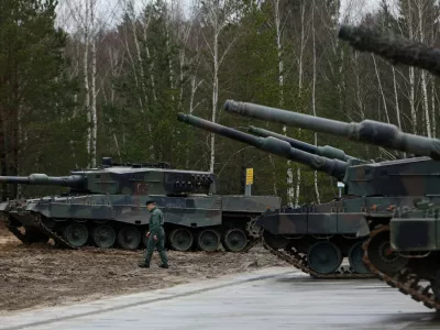 FILE - A Polish soldier walks next to the Leopard 2 tanks during a training at a military base and test range in Swietoszow, Poland, Monday, Feb. 13, 2023. (AP Photo/Michal Dyjuk, File)