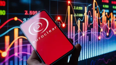 The Euroclear logo is displayed on a mobile phone with a stock graph seen in the background, in this photo illustration in Brussels, Belgium, on October 26, 2025. (Photo by Jonathan Raa/NurPhoto)NO USE FRANCE