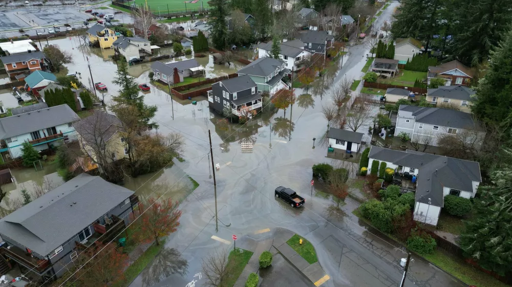 Some residential streets in downtown Snoqualmie, Wash., have standing water, Thursday morning, Dec. 11, 2025, as the downtown braces for a third crest of the Snoqualmie River later. (Ken Lambert/The Seattle Times via AP)