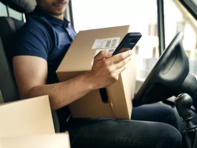 Close up of checking a package using portable information device