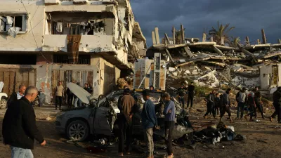 13 December 2025, Palestinian Territories, Gaza City: Palestinians inspect the site of an Israeli strike on a car in Gaza City. Photo: Omar Ashtawy/APA Images via ZUMA Press Wire/dpa