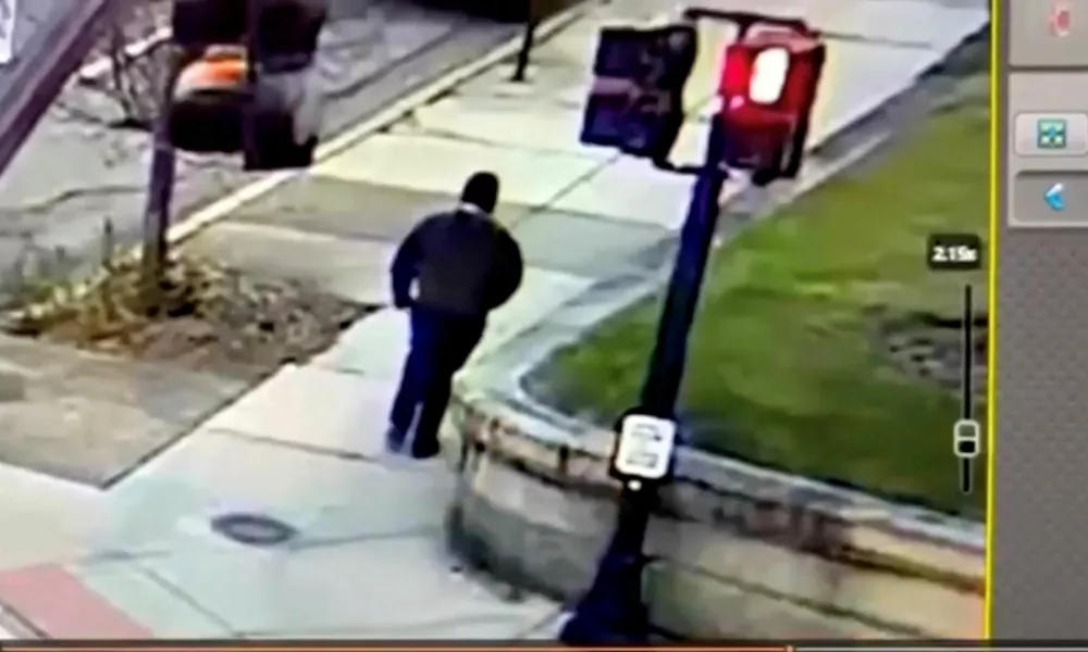 A monitor shows security camera footage of what police say is the Brown University shooting suspect walking along Hope Street after leaving the scene of shooting, in this screengrab taken from a handout video released December 13, 2025. Providence Public Information Officer/Handout via REUTERS  THIS IMAGE HAS BEEN SUPPLIED BY A THIRD PARTY. NO RESALES. NO ARCHIVES. MANDATORY CREDIT.  Verification Lines: Reuters was able to verify the location by road layout, road signs and the traffic lights match with file and satellite images. Reuters was not able to independently verify the Date. Providence Police Department stated that a shooting at Brown University caused 2 death and 9 injuries in Providence, Rhode Island on Saturday (December 13, 2025)