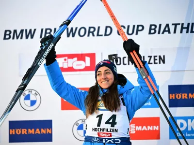 Biathlon - Biathlon World Cup - Hochfilzen, Austria - December 14, 2025 Women's 10km pursuit gold medallist, Italy's Lisa Vittozzi celebrates on the podium REUTERS/Christian Bruna
