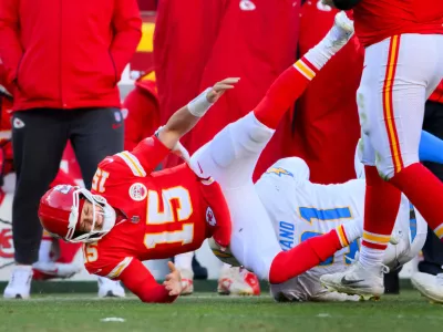 Kansas City Chiefs quarterback Patrick Mahomes (15) is injured after being tackled by Los Angeles Chargers defensive tackle Da'Shawn Hand (91) during the second half of an NFL football game, Sunday, Dec. 14, 2025 in Kansas City, Mo. (AP Photo/Reed Hoffmann)
