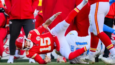 Kansas City Chiefs quarterback Patrick Mahomes (15) is injured after being tackled by Los Angeles Chargers defensive tackle Da'Shawn Hand (91) during the second half of an NFL football game, Sunday, Dec. 14, 2025 in Kansas City, Mo. (AP Photo/Reed Hoffmann)