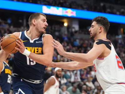 Denver Nuggets center Nikola Jokic pulls in a rebound as Houston Rockets center Alperen Sengun defends in the second half of an NBA basketball game Monday, Dec. 15, 2025, in Denver. (AP Photo/David Zalubowski)