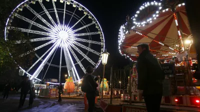 A giant ferris wheel is lit up on the opening night of 'Winter Wonderland', a christmas market and fun fair that is open to the public, in Hyde Park in London, Thursday, Nov. 17, 2011. (AP Photo/Kirsty Wigglesworth)