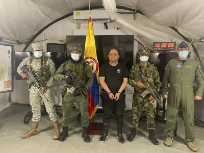 In this photo released by the Colombian presidential press office, one of the country&acirc;&euro;&trade;s most wanted drug traffickers, Dairo Antonio Usuga, alias &acirc;&euro;śOtoniel,&acirc;&euro;ť leader of the violent Clan del Golfo cartel, is presented to the media at a military base in Necocli, Colombia, Saturday, Oct. 23, 2021. (Colombian presidential press office via AP)