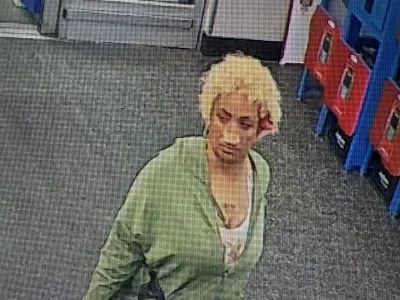 This undated photo taken from surveillance footage provided by the Biloxi Police Department shows Camille Benson walking at a Walmart store in Biloxi, Miss., where she allegedly pushed razor blades into loaves of bread. (Biloxi Police Department via AP)