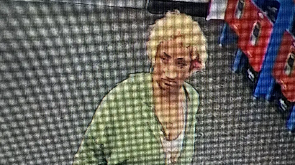 This undated photo taken from surveillance footage provided by the Biloxi Police Department shows Camille Benson walking at a Walmart store in Biloxi, Miss., where she allegedly pushed razor blades into loaves of bread. (Biloxi Police Department via AP)