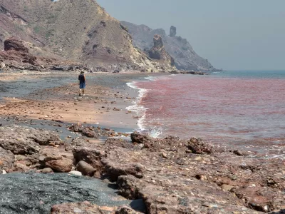 Hormuz Island, Hormozgan Province, Iran - 17 april, 2017: Iranian Island of Hormuz in Persian Gulf, A lonely traveler walks along the red beach along the surf line.,Image: 346861520, License: Royalty-free, Restrictions:, Model Release: no