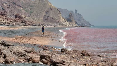 Hormuz Island, Hormozgan Province, Iran - 17 april, 2017: Iranian Island of Hormuz in Persian Gulf, A lonely traveler walks along the red beach along the surf line.,Image: 346861520, License: Royalty-free, Restrictions:, Model Release: no