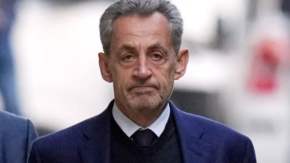 FILE - Former French President Nicolas Sarkozy leaves his home Tuesday, Oct. 21, 2025 in Paris as he heads to prison to serve time for a criminal conspiracy to finance his 2007 election campaign with funds from Libya. (AP Photo/Thibault Camus, File)