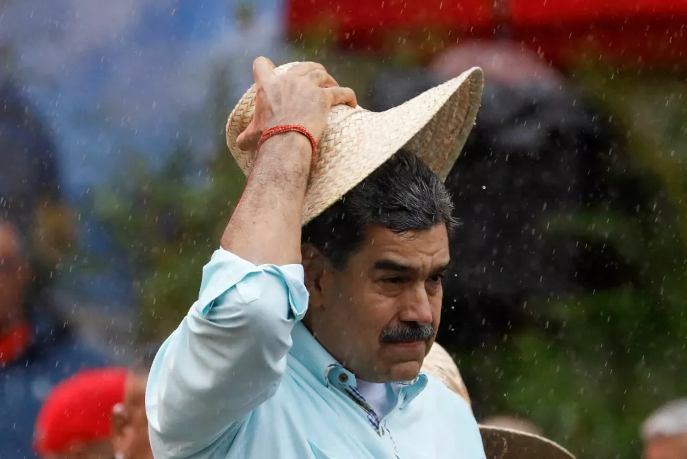 FILE PHOTO: Venezuela's President Nicolas Maduro holds a hat, as he joins his supporters during a march to commemorate the Battle of Santa Ines, on the same day Venezuelan opposition leader Maria Corina Machado was awarded the 2025 Nobel Peace Prize in Norway, in Caracas, Venezuela, December 10, 2025. REUTERS/Leonardo Fernandez Viloria/File Photo