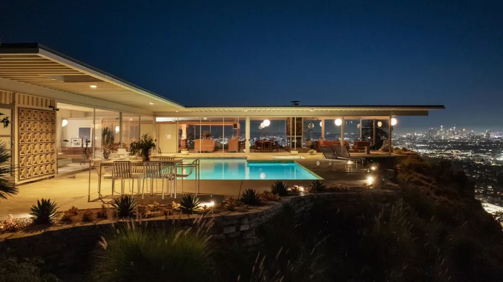 Story from Jam Press (Famous Hollywood House)Pictured: LA's Iconic Stahl House, also known as Case Study House #22.Famous Hollywood Stahl house hits market for the first time in 65 YEARSA luxurious house in Hollywood belonging to the famous Stahl family has hit the market for the first time in 65 years.And it comes with an impressive history.The home dates back to 1958, when it was commissioned by the Arts and Architecture magazine.It was part of a series of Case Study properties that were built as an experimental solution to the post-war housing boom.And not long after, it was snapped by the C.H. "Buck" Stahl, who was a painter, graphic designer and professional football player, reports&nbsp;Luxury Property News.It was made famous by photographer Julius Shulman, who pictured two women lounging in the home, as well as featuring in television shows and films such as Galaxy Quest, Columbo and Nurse Betty.The Stahl House &ndash;&nbsp;or Case Study House #22 &ndash;&nbsp;is located in the heart of Hollywood Hills; just a mile away from Sunset Strip.It boasts 270-degree views of Los Angeles and sprawls across 2,200 sq ft.Inside, the design is modern and simple.Dark brown tones contrast against beige walls, ceilings and flooring &ndash;oozing a sense of luxury.In the kitchen, a plaque is proudly positioned to mark its title in history, crowning it a historic-cultural monument.Glass walls adorn the place from top-to-bottom, allowing natural sunlight to flow through and further expand the open-plan living space.A central fireplace in the living room is great for entertaining guests on a cold evening.And access to outside via sliding doors brings focus onto the expansive swimming pool.Then, the money shot, the view of the city's twinkling lights.Pierre Koenig, who crafted the home, made sure it was one-of-a-kind; including frames of the Hollywood Sign from the bathroom.Accessed via a gated drive, privacy and security is at the forefront of its design.And with neighbours including Leonardo DiCaprio, Kenau Reeves, Halle Berry and Taylor Swift, it's a certain showstopper.The current owners have offered public tours since 2007 &ndash;&nbsp;but now, for the first time in 65 years, it's on the market for a cool 5m (USD) (Ł18.6m).The listing, which features on&nbsp;Top 10 Real Estates, is held by William Baker of the Agency Beverly Hills.ENDSEDITOR'S NOTE: All press must include mention of Top 10 Real Estate Deals as per condition of use. Digital press must hyperlink where possible:&nbsp;https://toptenrealestatedeals.com/weekly-ten-best-home-deals/home/las-iconic-stahl-house-most-famous-us-modern-home-since-fallingwater-lists-for-25-million,Image: 1059667994, License: Rights-managed, Restrictions: EDITOR'S NOTE: All press must include mention of Top 10 Real Estate Deals as per condition of use. Digital press must hyperlink where possible:&nbsp;https://toptenrealestatedeals.com/weekly-ten-best-home-deals/home/las-iconic-stahl-house-most-famous-us-modern-h, Model Release: no