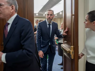 Former Department of Justice Special Counsel Jack Smith, center, and his attorney Lanny Breuer, left, depart at the end of a Republican-led deposition before the House Judiciary Committee as part of its oversight into DOJ investigations into President Donald Trump, on Capitol Hill in Washington, Wednesday, Dec. 17, 2025. (AP Photo/J. Scott Applewhite)