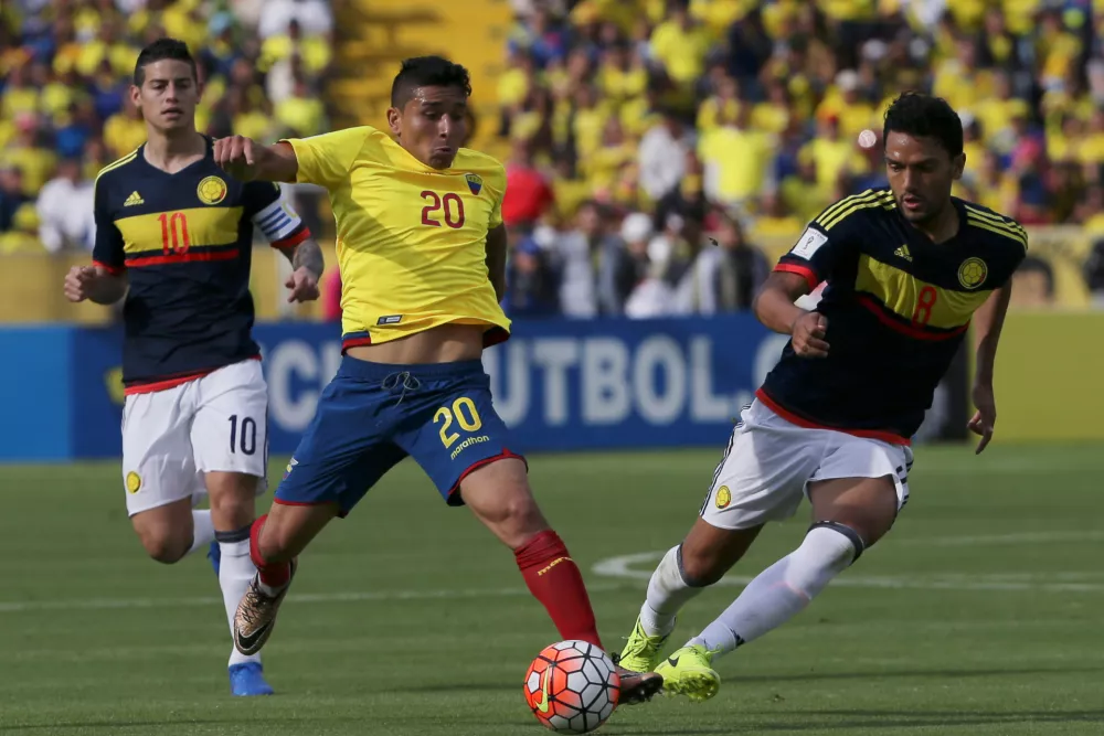 FILE - Ecuador's Mario Pineida, center, and Colombia's Abel Aguilar battle for the ball during their 2018 World Cup qualifying soccer match at the Atahualpa Olympic Stadium in Quito, Ecuador, March 28, 2017. (AP Photo/Dolores Ochoa, File)