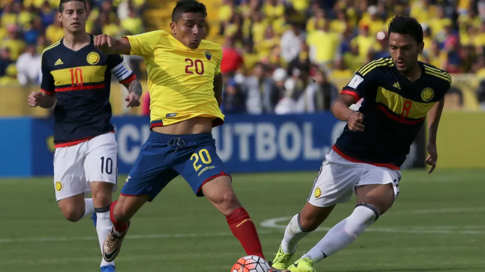 FILE - Ecuador's Mario Pineida, center, and Colombia's Abel Aguilar battle for the ball during their 2018 World Cup qualifying soccer match at the Atahualpa Olympic Stadium in Quito, Ecuador, March 28, 2017. (AP Photo/Dolores Ochoa, File)