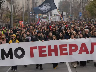 People hold a banner that reads: "We do not give army headquarters" during a protest in front of military complex that was partially destroyed in a NATO bombing campaign in 1999, after Serbian lawmakers on Friday passed a special law clearing the way for a controversial real estate project that would be financed by an investment company linked to President Trump's son-in-law Jared Kushner, in Belgrade, Serbia, Tuesday, Nov. 11, 2025. (AP Photo/Darko Vojinovic)