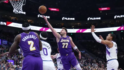 Los Angeles Lakers guard Luka Doncic (77) lays up the ball against the Utah Jazz during the first quarter of an NBA basketball game Thursday, Dec. 18, 2025, in Salt Lake City. (AP Photo/Rob Gray)