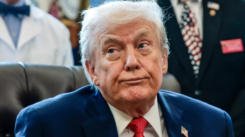 U.S. President Donald Trump looks on as he signs an executive order recommending loosening the federal regulations on marijuana, in the Oval Office at the White House in Washington, D.C., U.S., December 18, 2025. REUTERS/Evelyn Hockstein   TPX IMAGES OF THE DAY