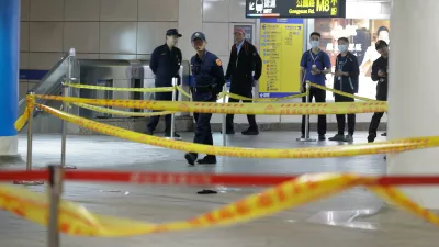 Taiwan police cordoned off the scene after a knife attack in Taipei, Taiwan, Friday, Dec. 19, 2025. (AP Photo/Chiang Ying-ying)
