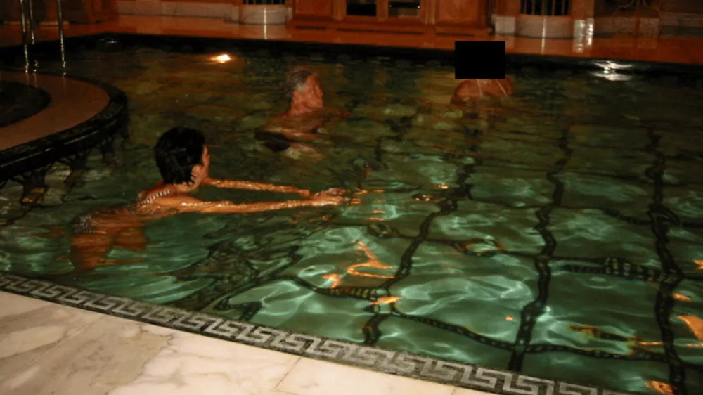 Former U.S. President Bill Clinton swims in a pool in this image released by the Department of Justice in Washington, D.C., U.S., on December 19, 2025 as part of a new trove of documents from its investigations into the late financier and convicted sex offender Jeffrey Epstein. U.S. Justice Department/Handout via REUTERS  THIS IMAGE HAS BEEN SUPPLIED BY A THIRD PARTY REDACTED AREAS FROM SOURCE. THIS PICTURE WAS PROCESSED BY REUTERS TO ENHANCE QUALITY. AN UNPROCESSED VERSION HAS BEEN PROVIDED SEPARATELY.