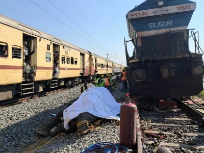 Train passengers use their mobile phones to take photographs of a dead elephant after it was hit by a train in Hojai district in the eastern state of Assam, India, December 20, 2025. REUTERS/Biki Das