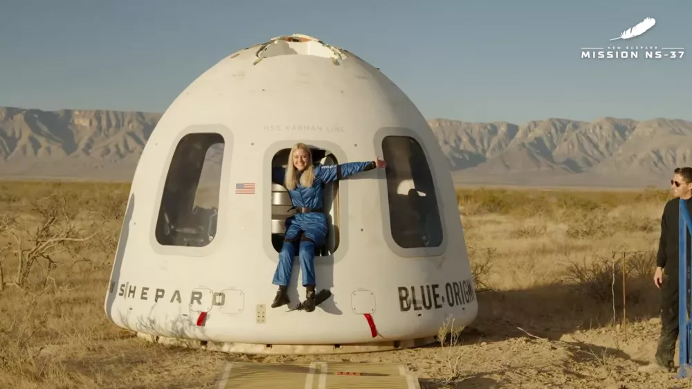 This image provided by Blue Origin, Michaela Benthaus poses after the Blue Origin's capsule landed on Saturday, Dec. 20, 2025 in West Texas. (Blue Origin via AP)
