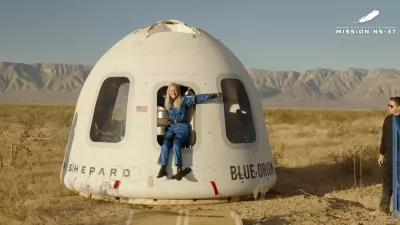 This image provided by Blue Origin, Michaela Benthaus poses after the Blue Origin's capsule landed on Saturday, Dec. 20, 2025 in West Texas. (Blue Origin via AP)