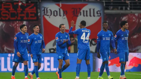 Montrell Culbreath of Bayer Leverkusen, third from left, celebrates with teammates after scoring to make it 1:3 during the Bundesliga soccer match between RB Leipzig and Bayer Leverkusen, in Leipzig, Germany, Saturday Dec. 20, 2025. (Jan Woitas/dpa via AP)