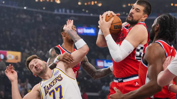 Los Angeles Clippers center Ivica Zubac, left, gets a rebound against Los Angeles Lakers forward/guard Luka Doncic during the first half of an NBA basketball game Saturday, Dec. 20, 2025, in Inglewood, Calif. (AP Photo/Jae C. Hong)