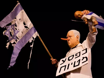 A demonstrator holds a doll as Israelis protest against Israeli Prime Minister Benjamin Netanyahu and his government and demand a state commission of inquiry into the deadly October 7, 2023 attack by Hamas, in Tel Aviv, Israel, November 22, 2025. REUTERS/Amir Cohen