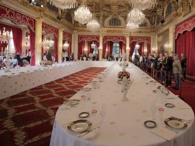 FILE - Visitors view a table dressed with plates and glasses for official dinners at the Elysee Palace in Paris, Saturday, Sept. 15, 2012. France's national buildings and administrations were opened to the public for Heritage Days weekend. (AP Photo/Christophe Ena, File)